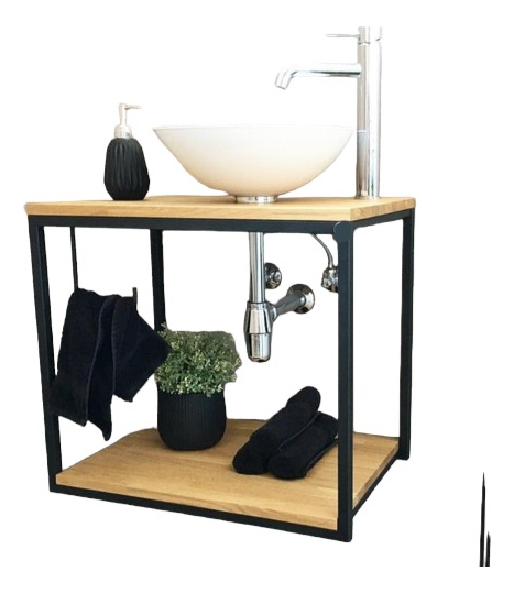 Lavabo moderno con estructura metálica, lavamanos blanco, toallas negras y decoración vegetal.