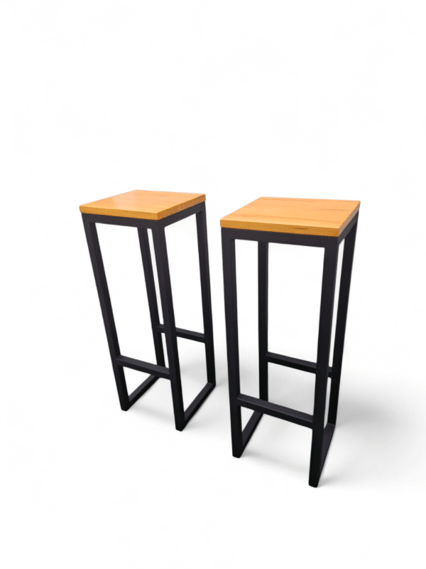 Dos taburetes altos con asientos de madera y estructura de metal negro. Ideales para barras de cocina modernas o espacios de bar, combinando estilo y funcionalidad.