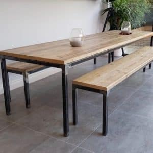 Mesa de comedor y banco de madera con estructura metálica negra, estilo industrial. Diseño minimalista y contemporáneo, ideal para interiores modernos y espacios amplios.