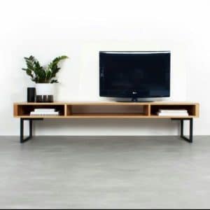 Mueble de TV moderno y minimalista de madera clara con patas metálicas negras. Incluye compartimentos abiertos para almacenamiento y decoración. Diseño elegante y funcional.